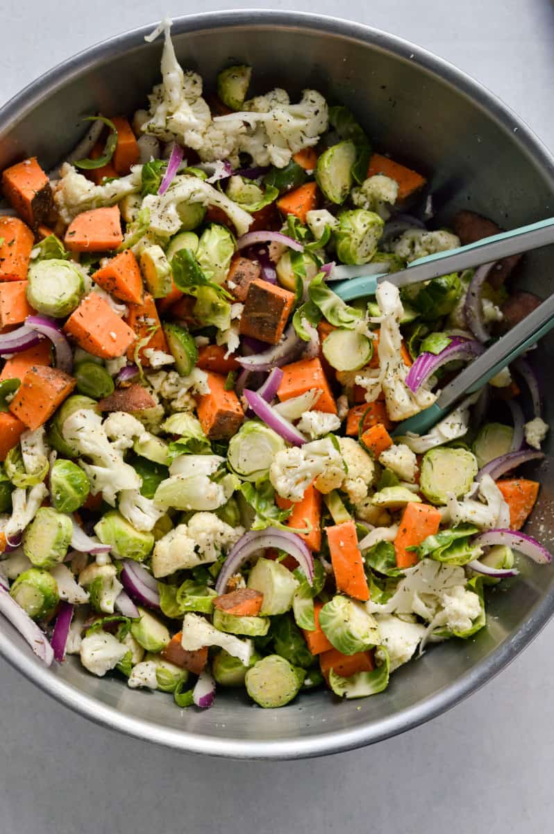Mixing veggies in spices.