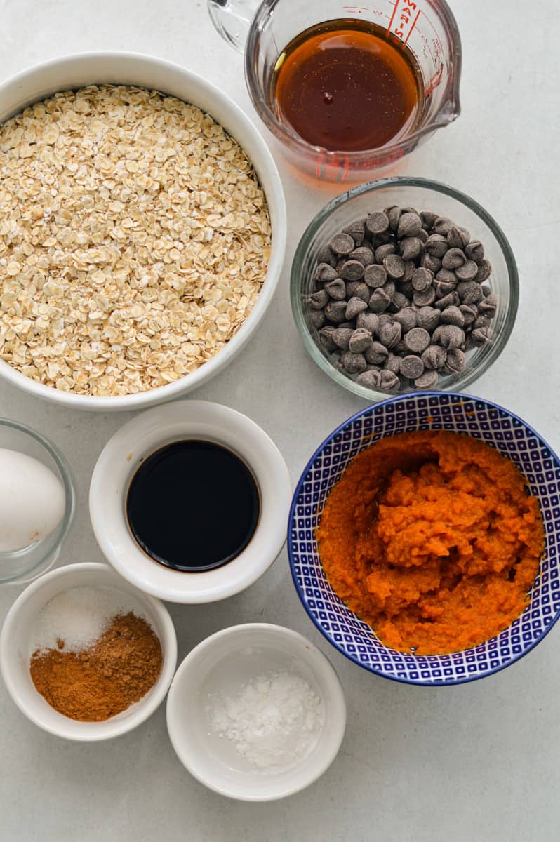 Ingredients including egg, chocolate chips, gluten free oats, maple syrup, pumpkin puree, pumpkin spice, vanilla and salt.