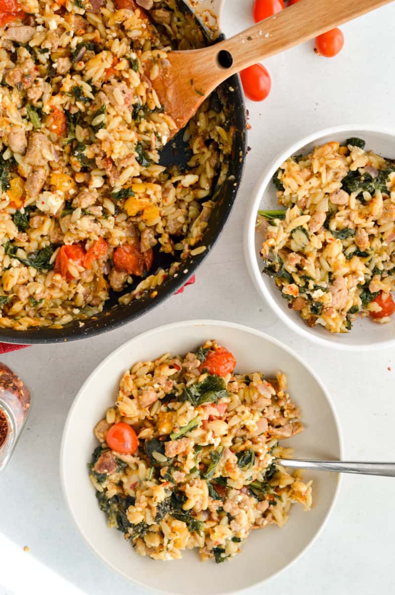 Serving two bowls of butternut squash orzo.
