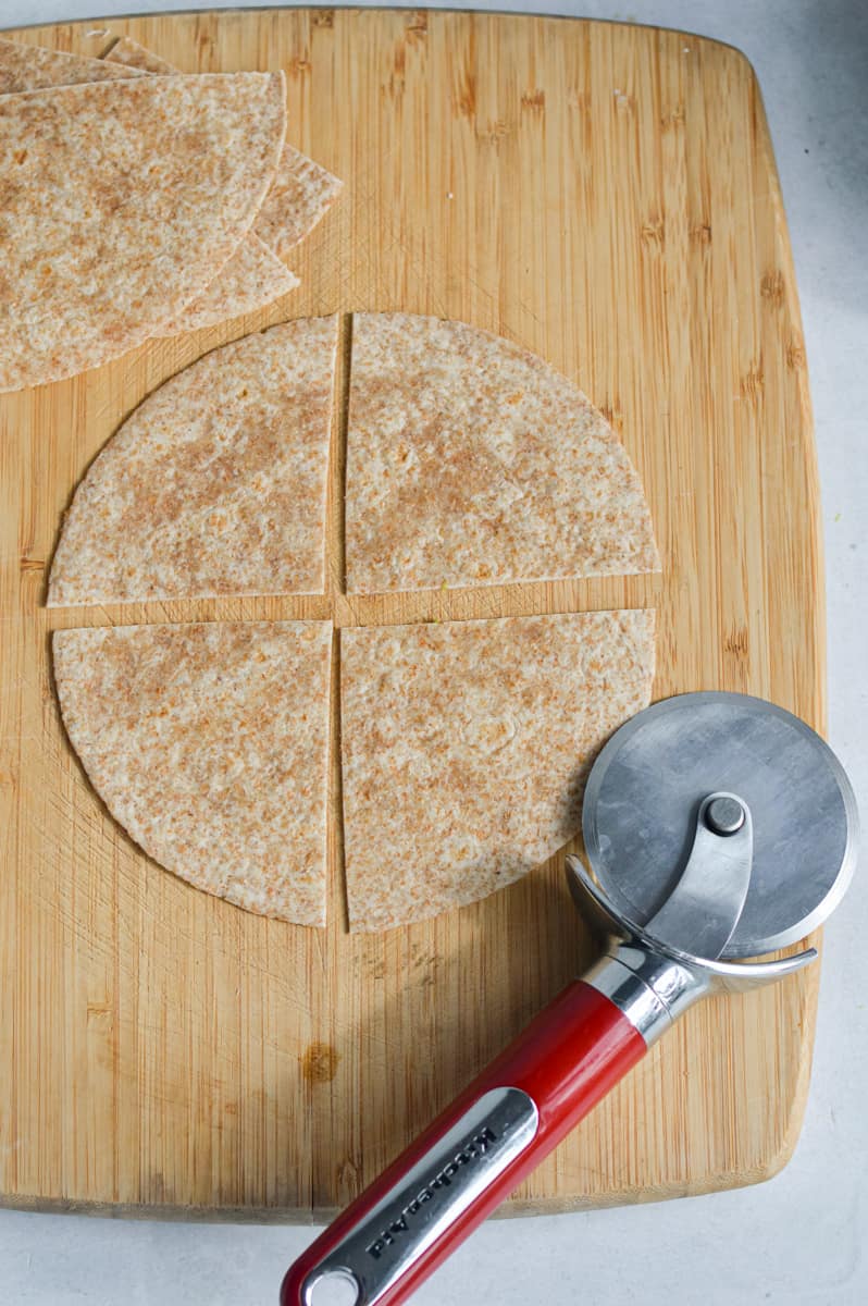 Slicing a tortilla into quarters.