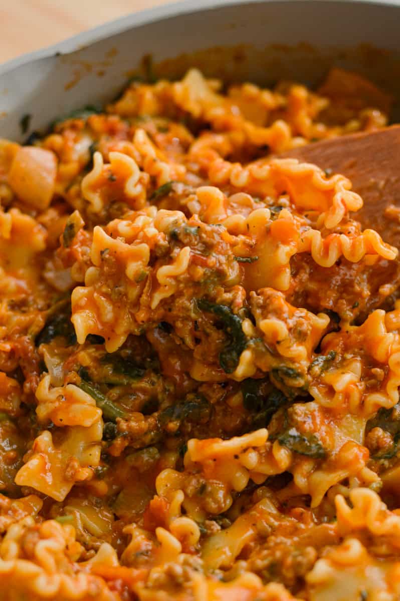 Taking a scoop of cheesy hamburger helper lasagna.