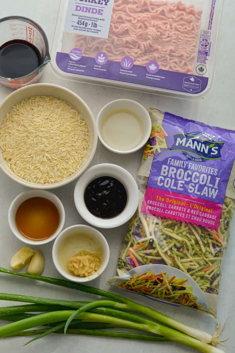 Ingredients including sesame oil, green onions, ground turkey, coleslaw, rice, hoisin sauce, garlic, ginger, soy sauce, and rice vinegar.