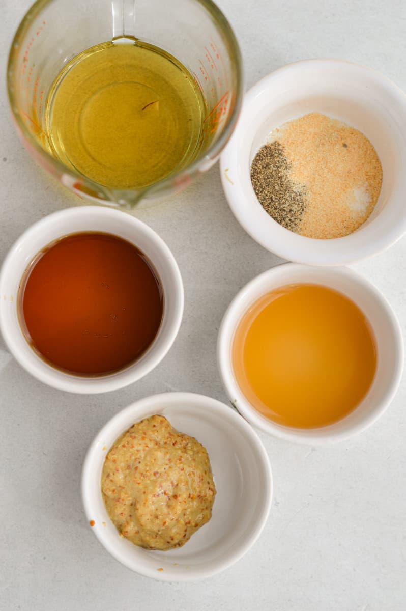 Ingredients including olive oil, dijon mustard, apple cider vinaiger, maple syrup and black pepper.