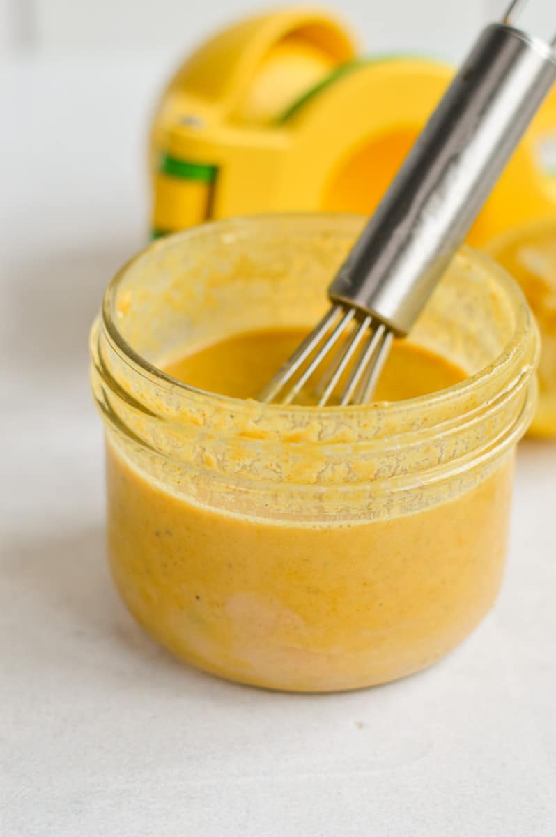 Whisking together curry tahini dressing.