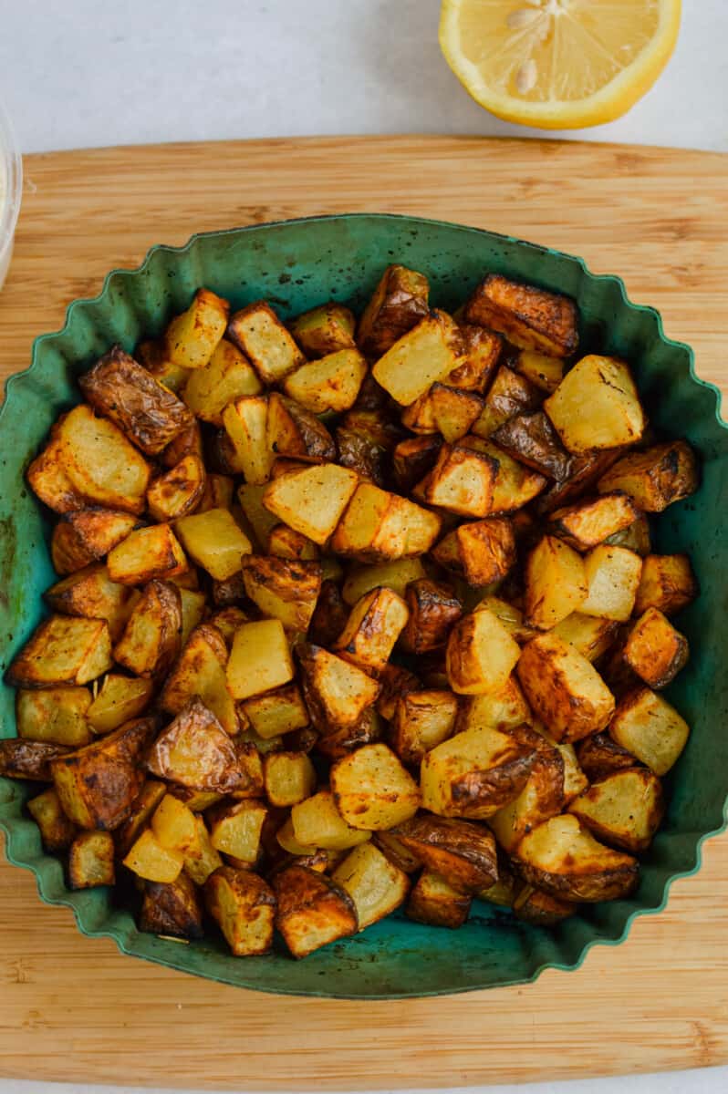 Crispy potatoes in the air fryer basket.