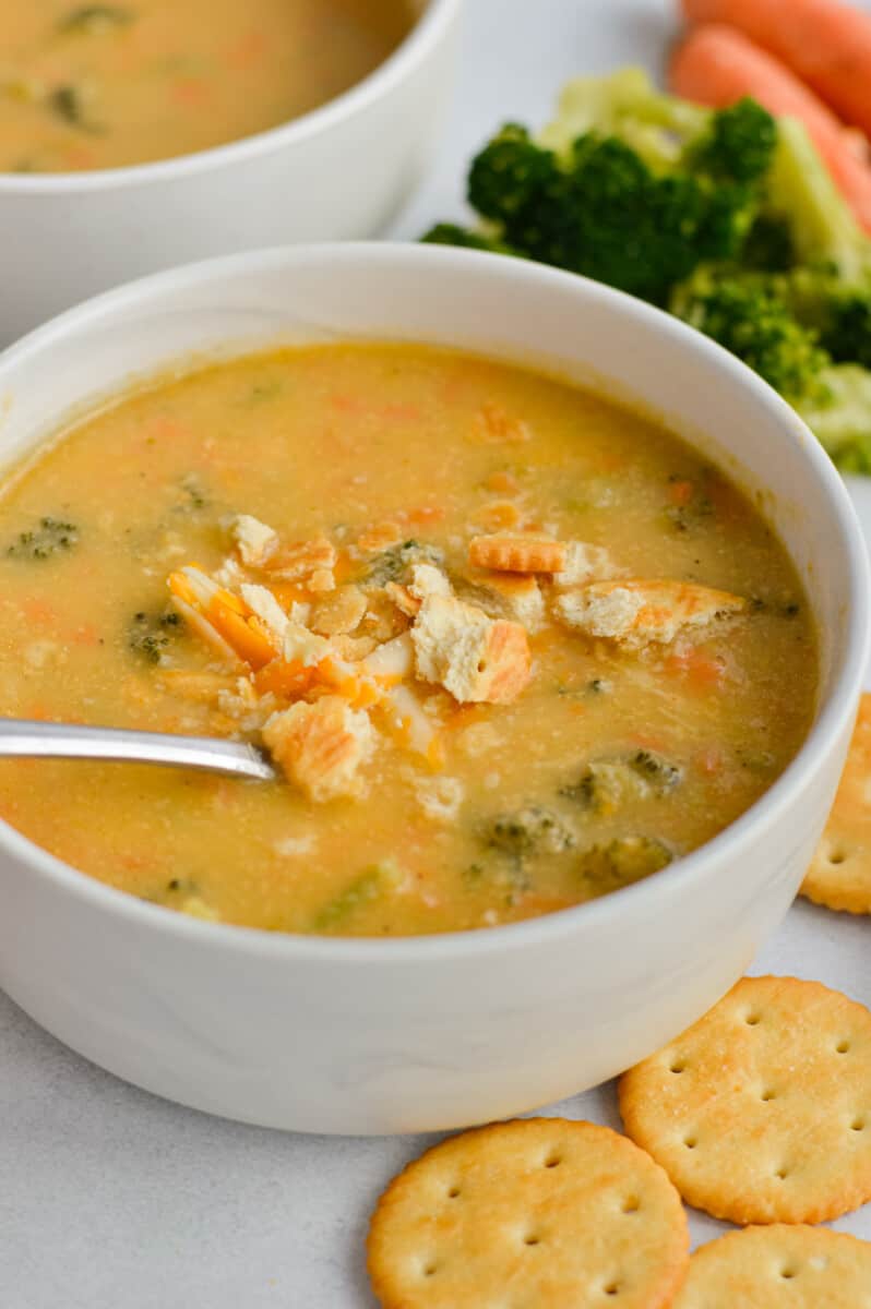 Bowl of broccoli cheddar soup served with crackers.