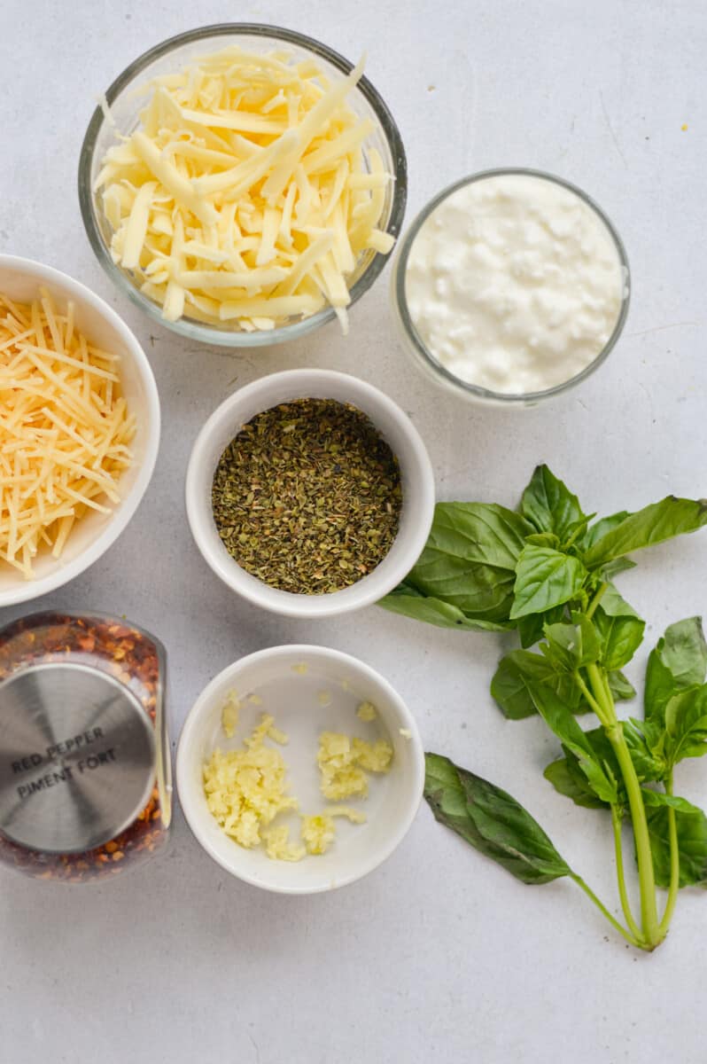 Ingredients including mozzarella, parmesan, basil, seasoning, garlic, and cottage cheese.