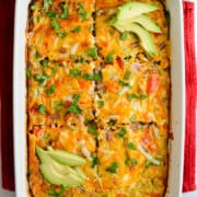 Chorizo, egg & green chili breakfast casserole topped with sliced avocado.