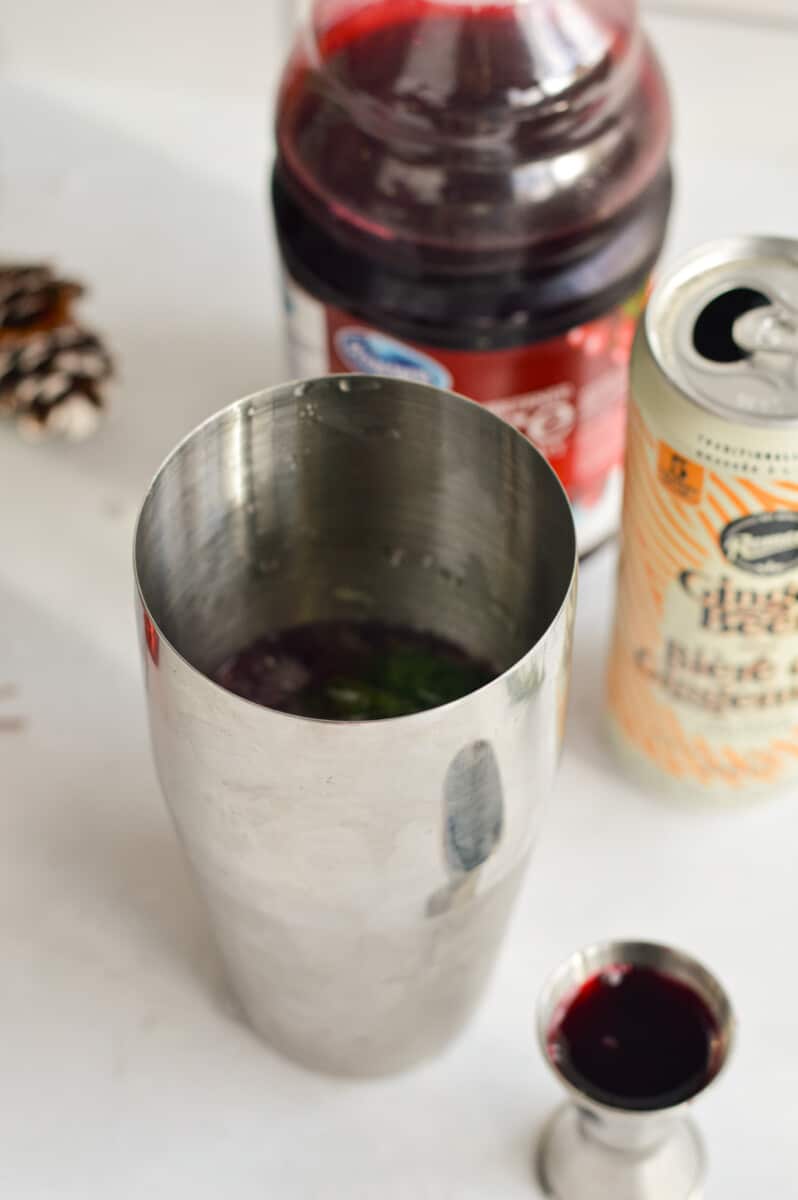 Adding ingredients into a cocktail shaker.