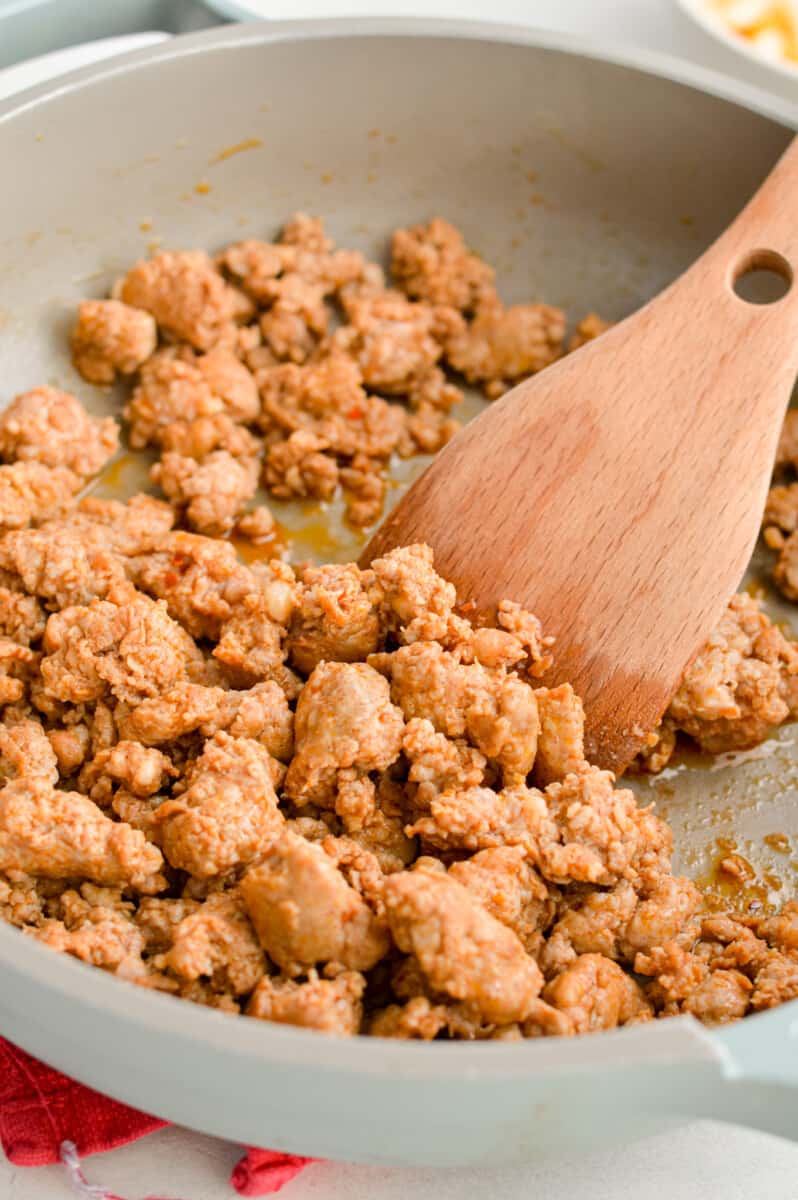 Cooking chorizo in a pan.