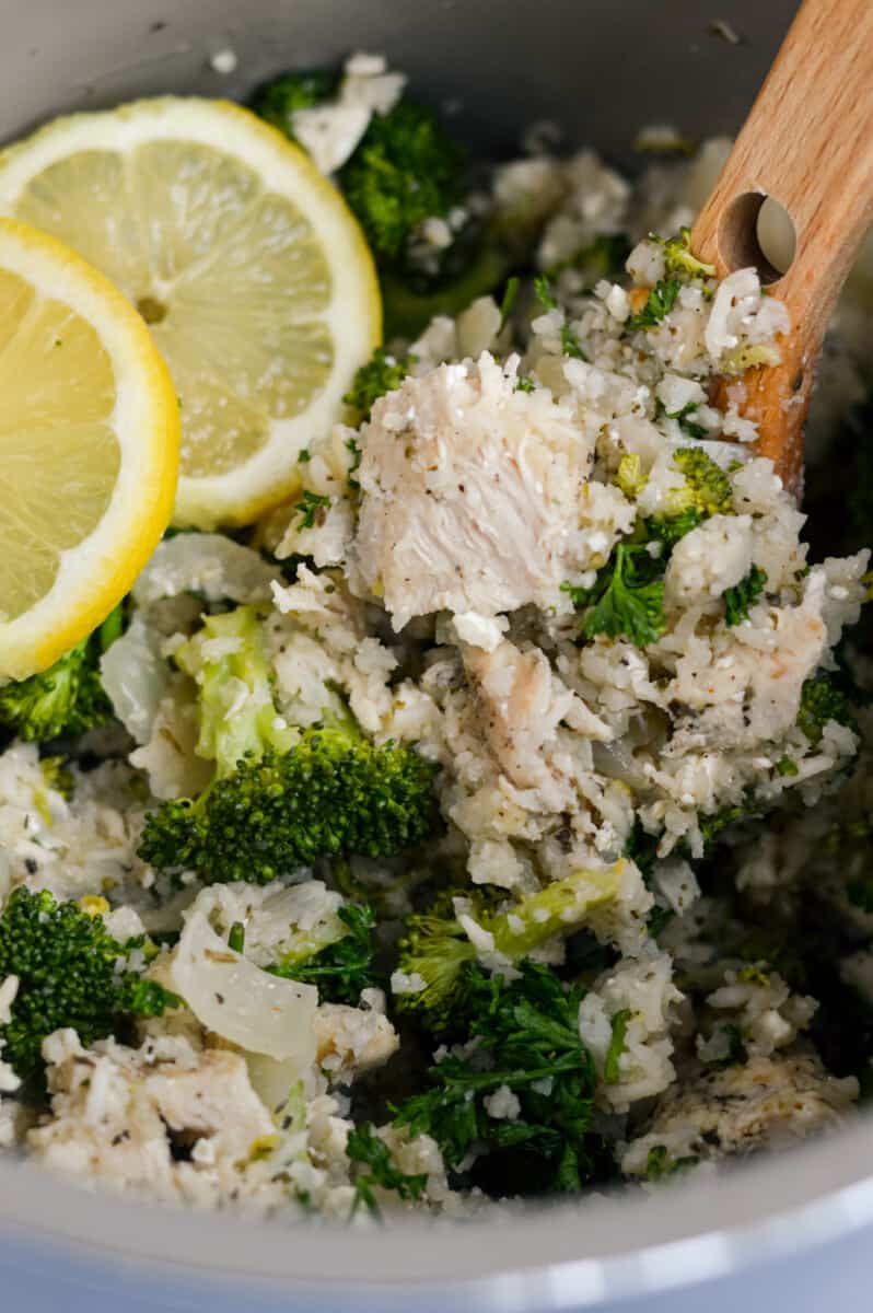 Close up of lemon chicken and rice with broccoli in a crockpot.