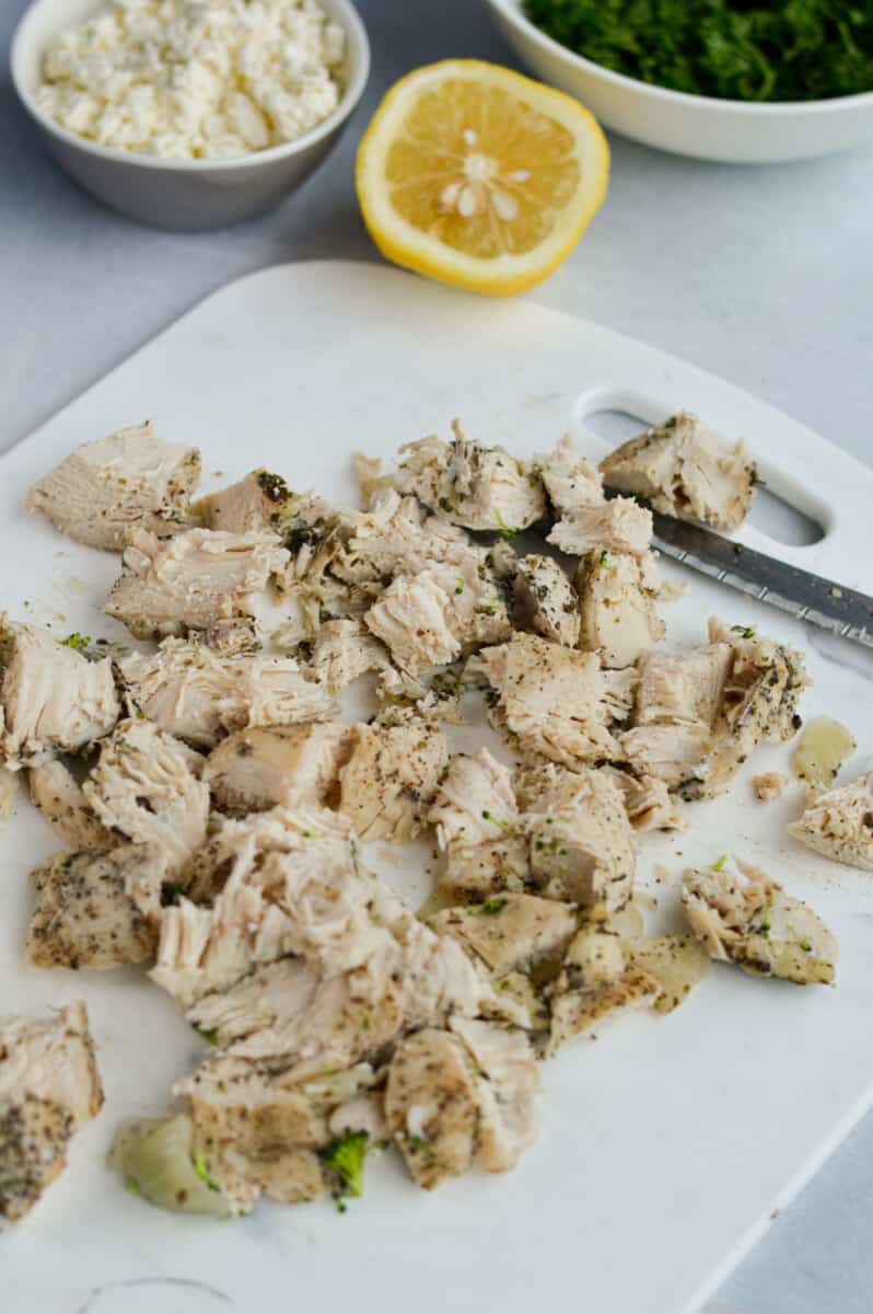 Dicing chicken into bite sized pieces.
