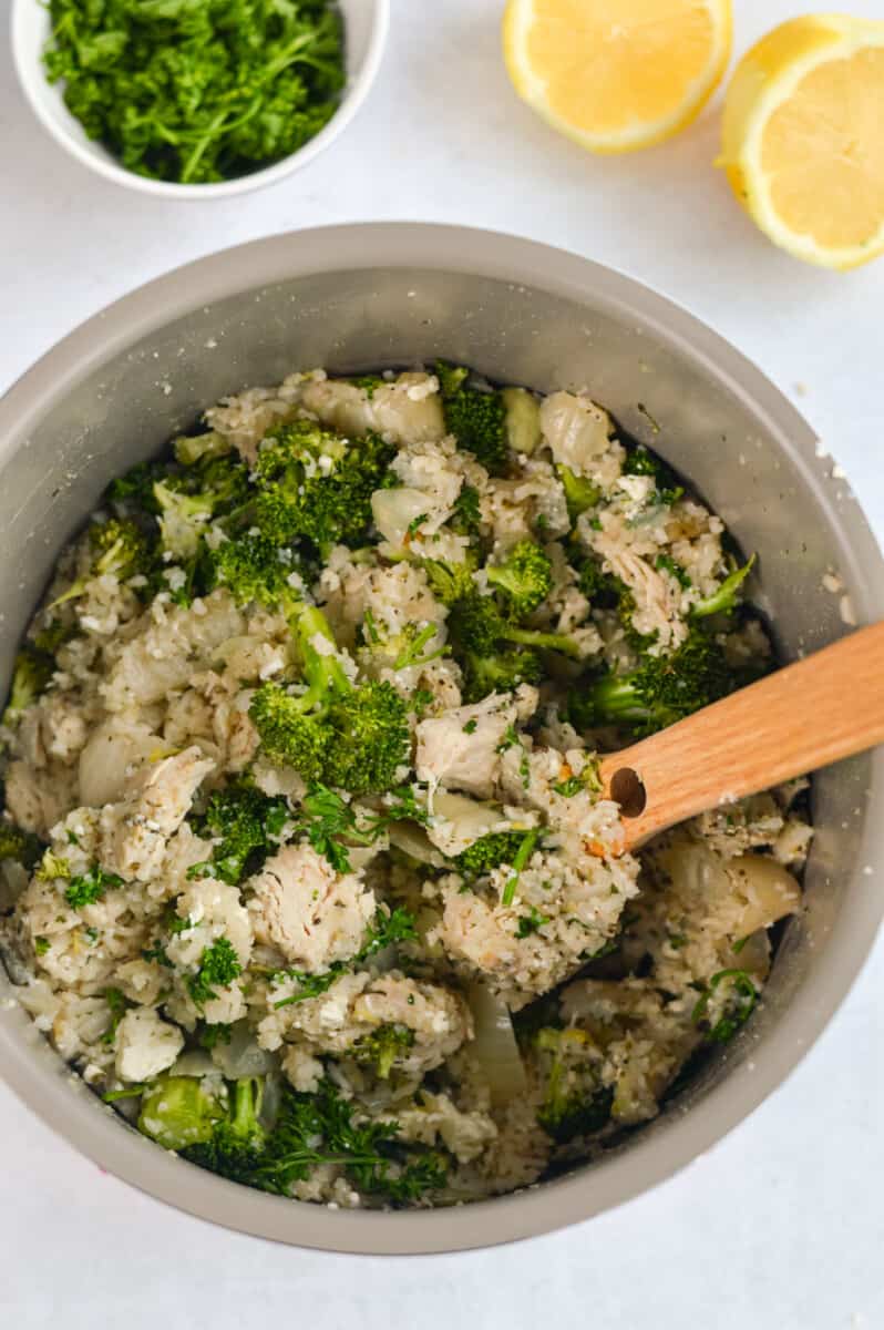 Mixing crockpot chicken and rice.