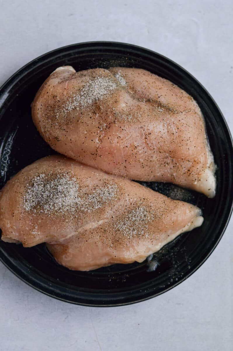 Seasoned chicken breast with salt and pepper.