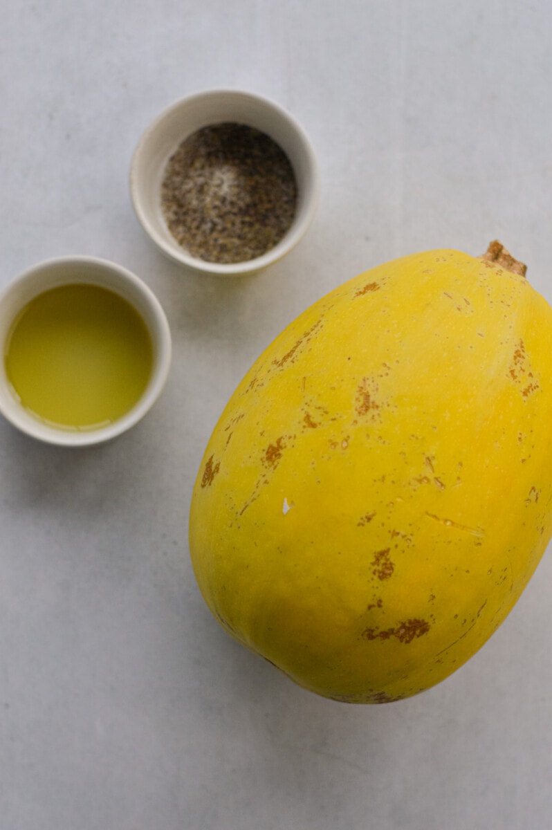 Ingredients including spaghetti squash, olive oil and seasoning.
