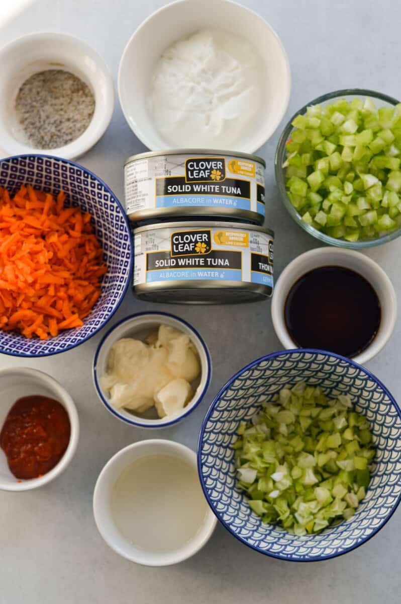 Ingredients including canned tuna, celery, shredded carrot, green onion, mayo, Greek yogurt, soy sauce, hot sauce, rice vinegar and seasoning.