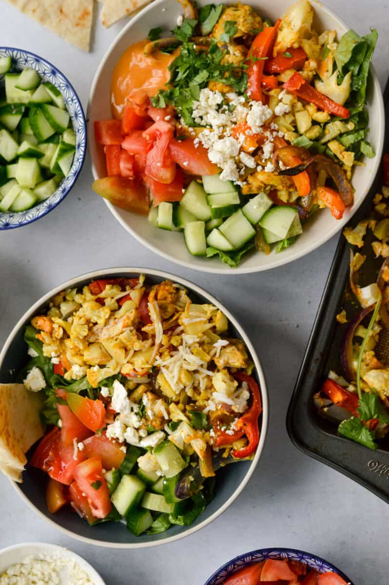 Birds eye of two sheet pan chicken shawarma bowls.