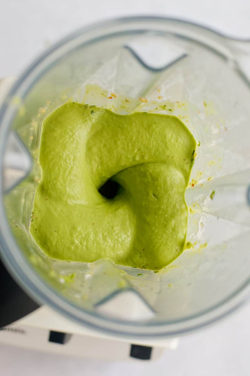 Blending ingredients to make avocado green goddess dressing.