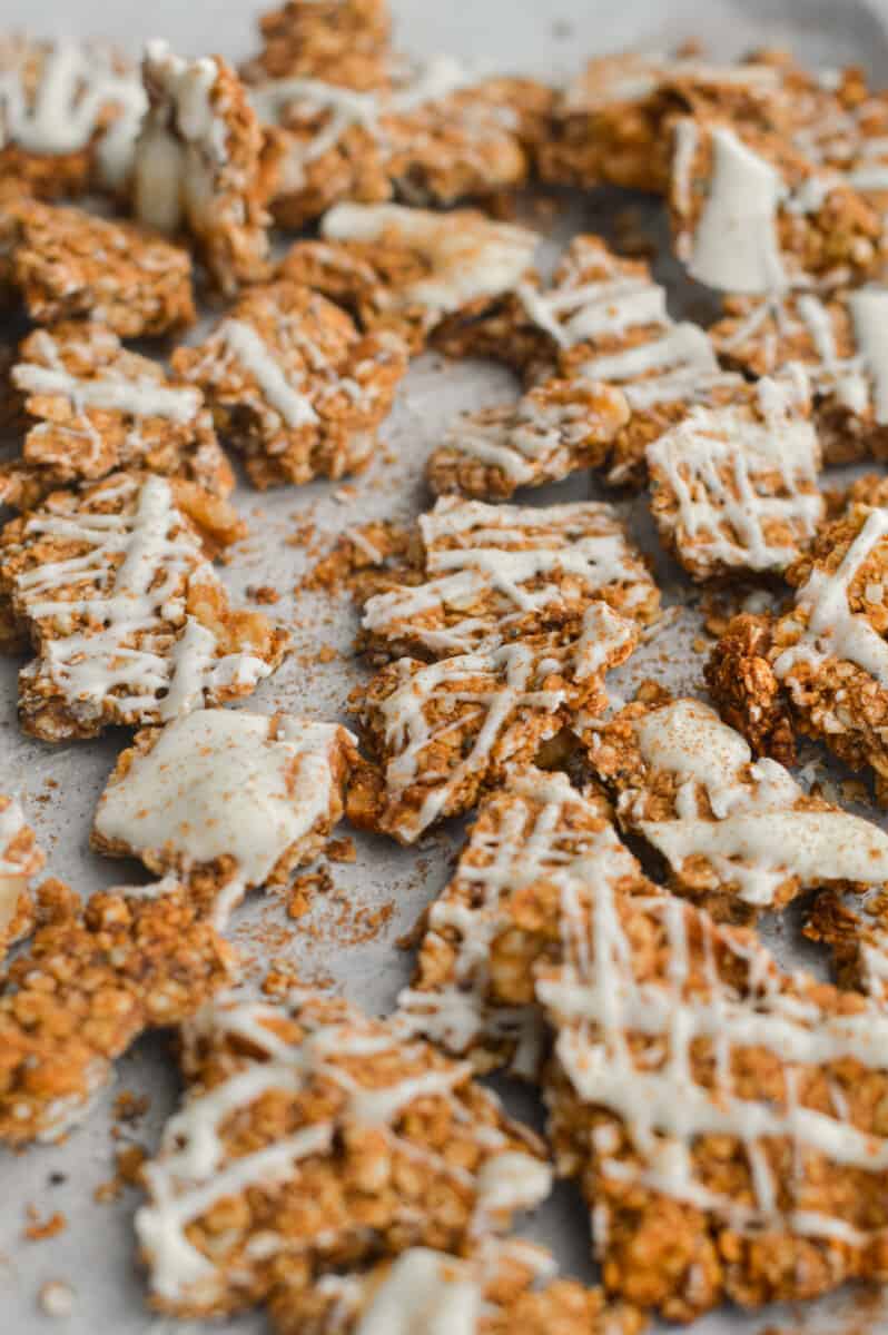 Chunks of cinnamon roll granola with white chocolate drizzle.