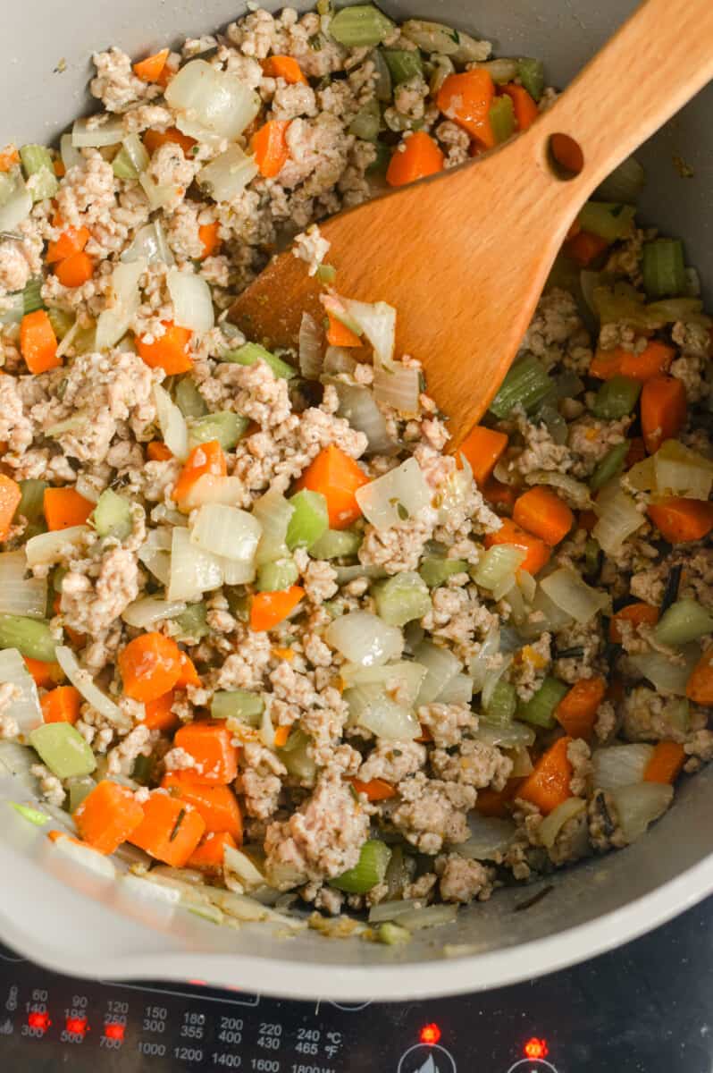 Cooking mirepoix with ground turkey.