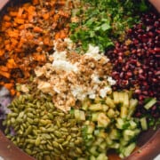 Birds eye of crunchy kale winter salad with pomegranate, cucumber, pumpkin seeds, parsley, sweet potato, quinoa and feta cheese.