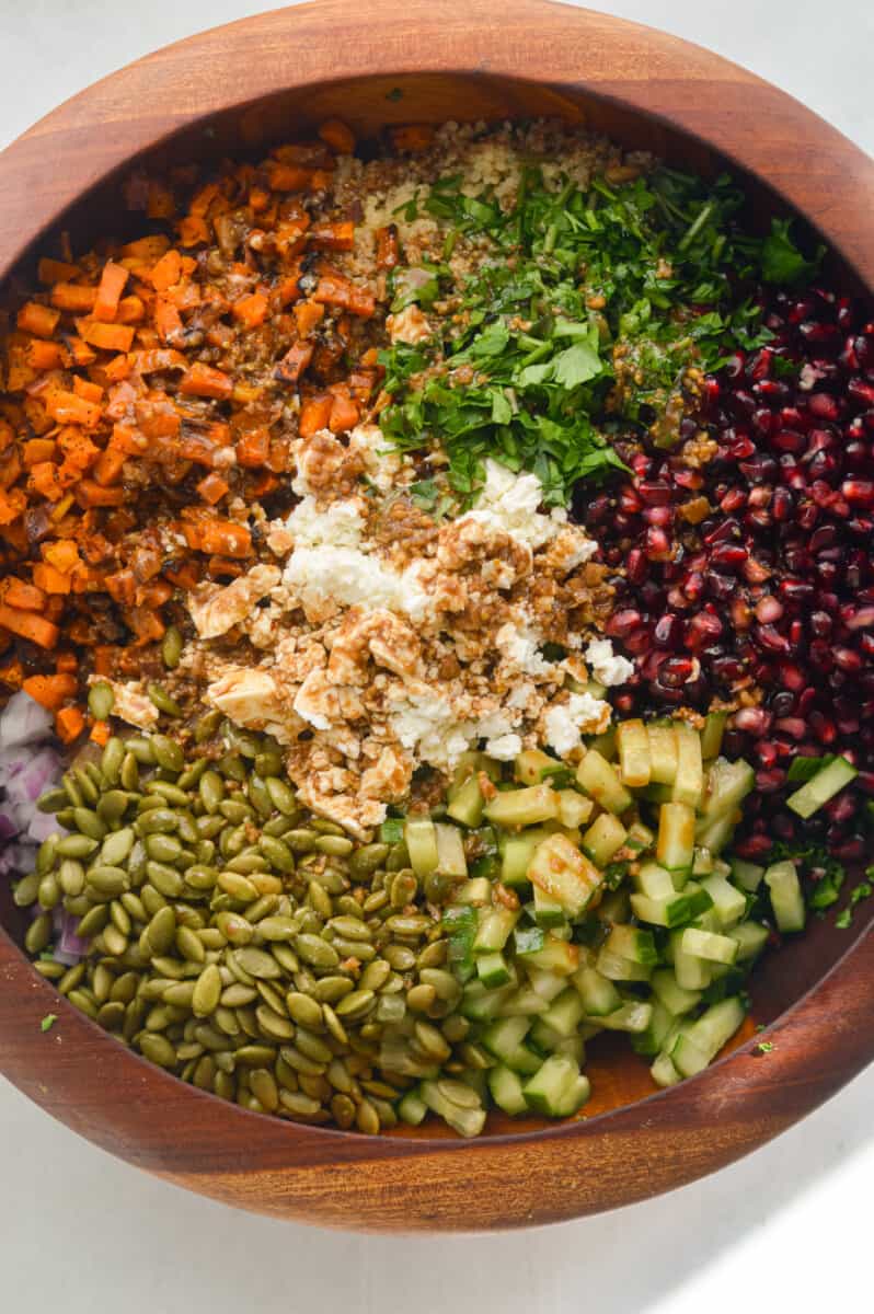 Birds eye of crunchy kale winter salad with pomegranate, cucumber, pumpkin seeds, parsley, sweet potato, quinoa and feta cheese.