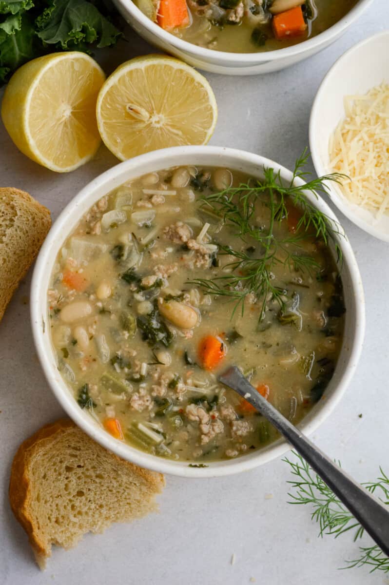 Bowl of lemon white bean soup with turkey and greens.