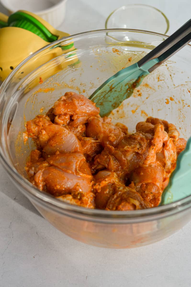 Marinating chicken thighs in olive oil, lemon juice, garlic and spice mix.