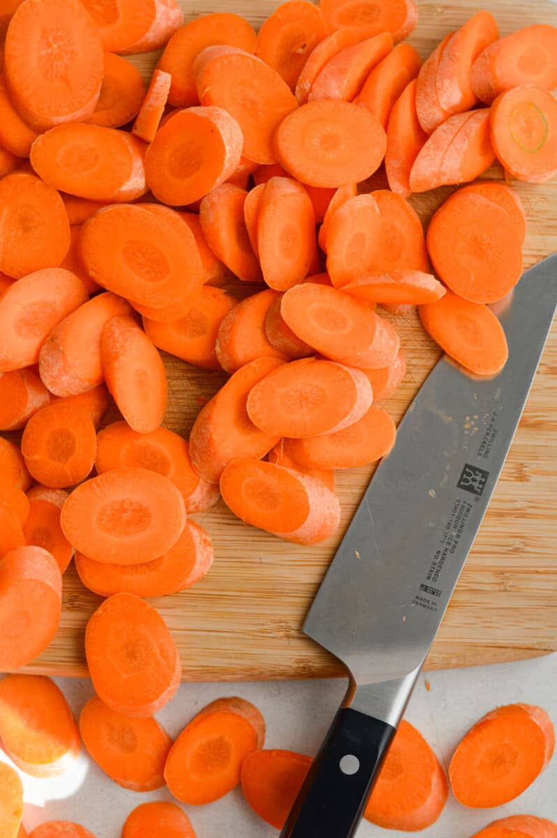 Slicing carrots into ½ inch thick rounds.