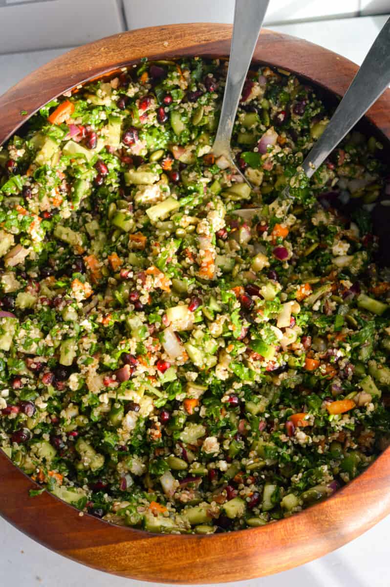 Tossing kale winter salad.