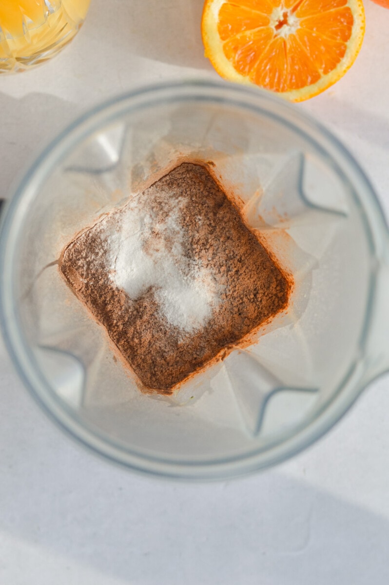 Blending oats, cocoa powder, orange juice, baking powder and salt in a blender.