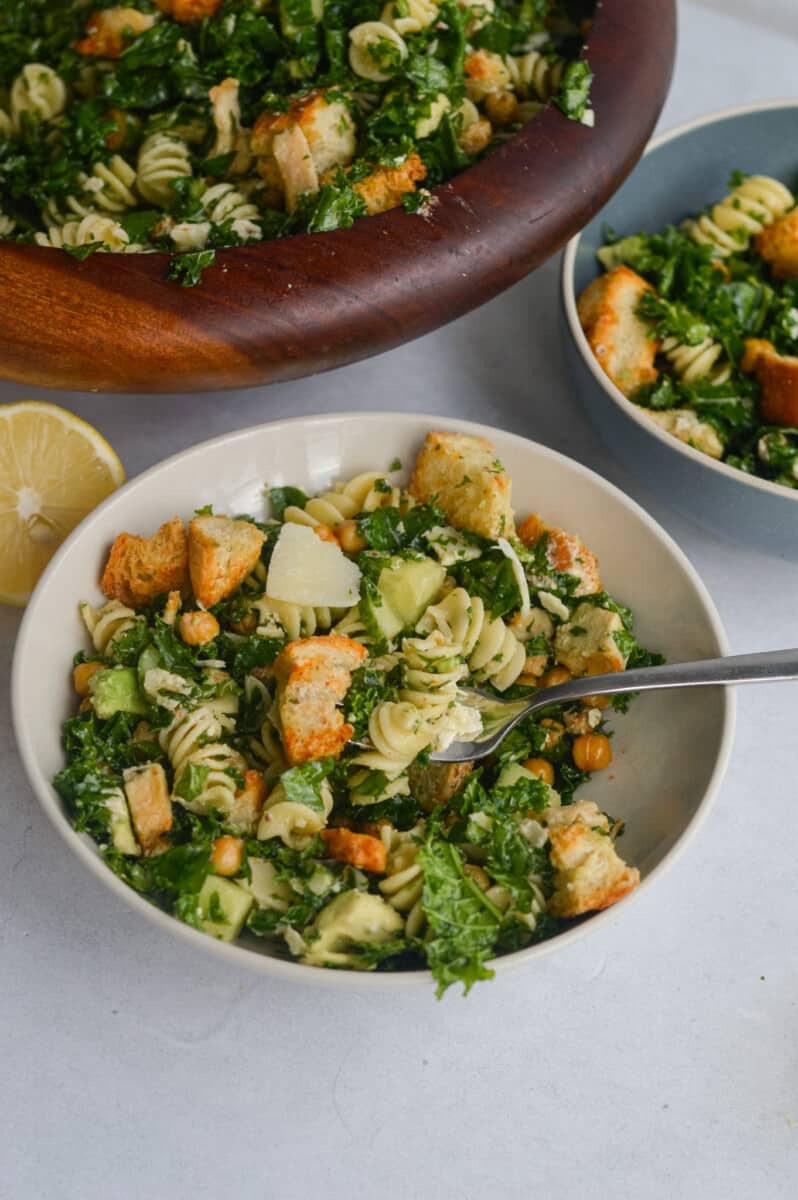Serving bowls of kale Caesar pasta salad.