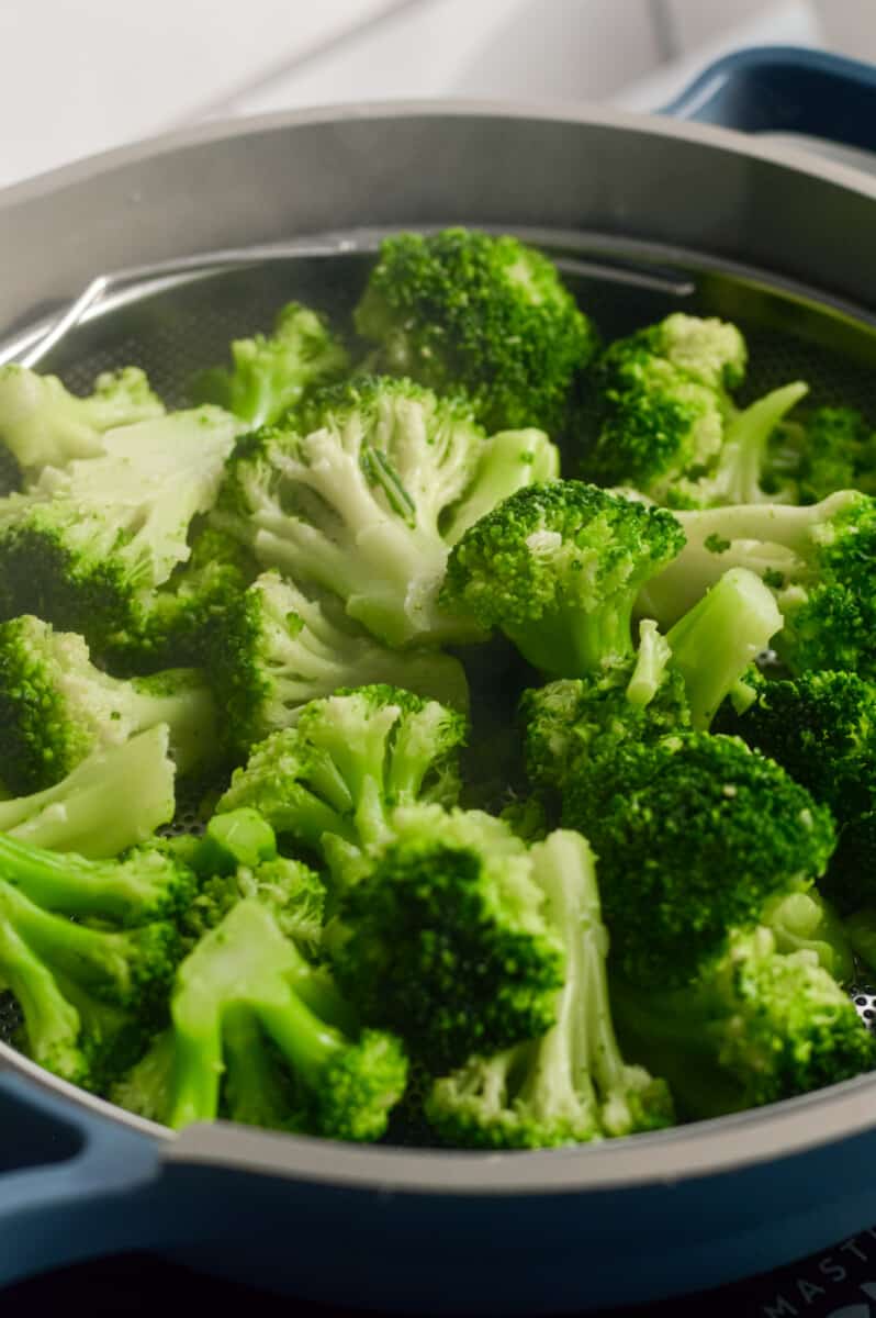 Steaming frozen broccoli florets.