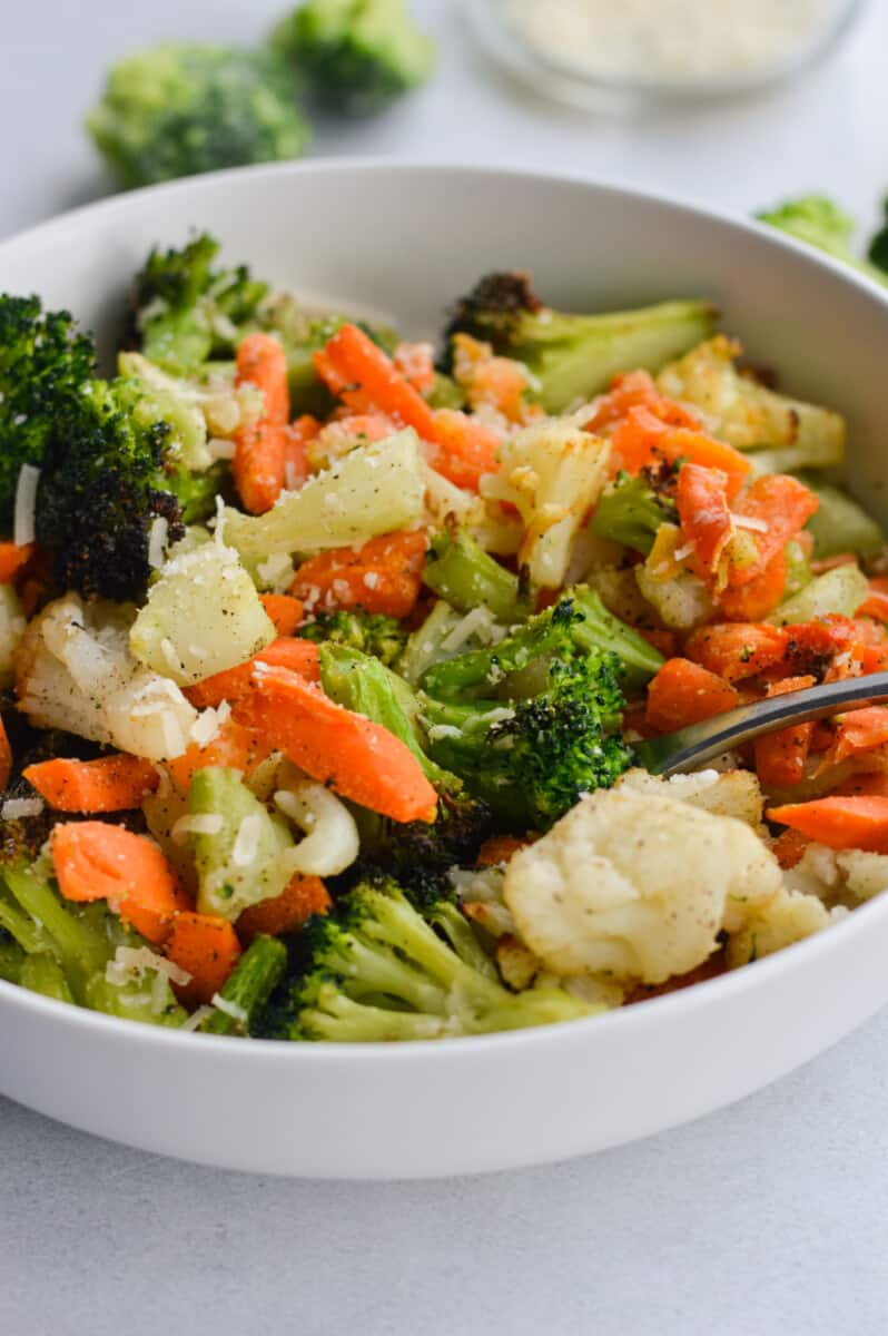 Bowl of air fryer frozen vegetables including carrots, cauliflower and broccoli.