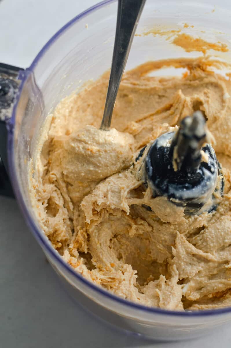 Blending cottage cheese, peanut butter, maple syrup and vanilla extract in a food processor.