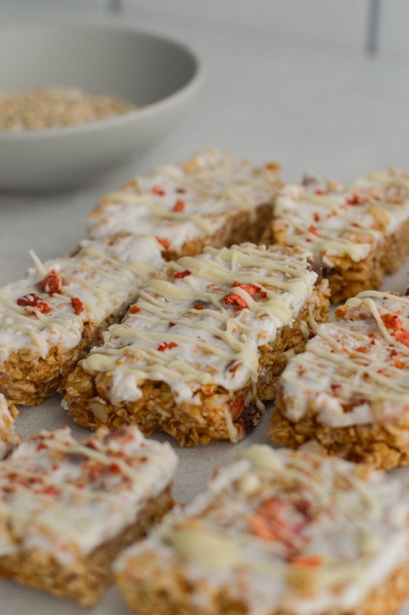 Granola yogurt bars with white chocolate drizzle.
