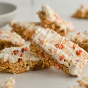 Stacks of granola yogurt bars with white chocolate drizzle.