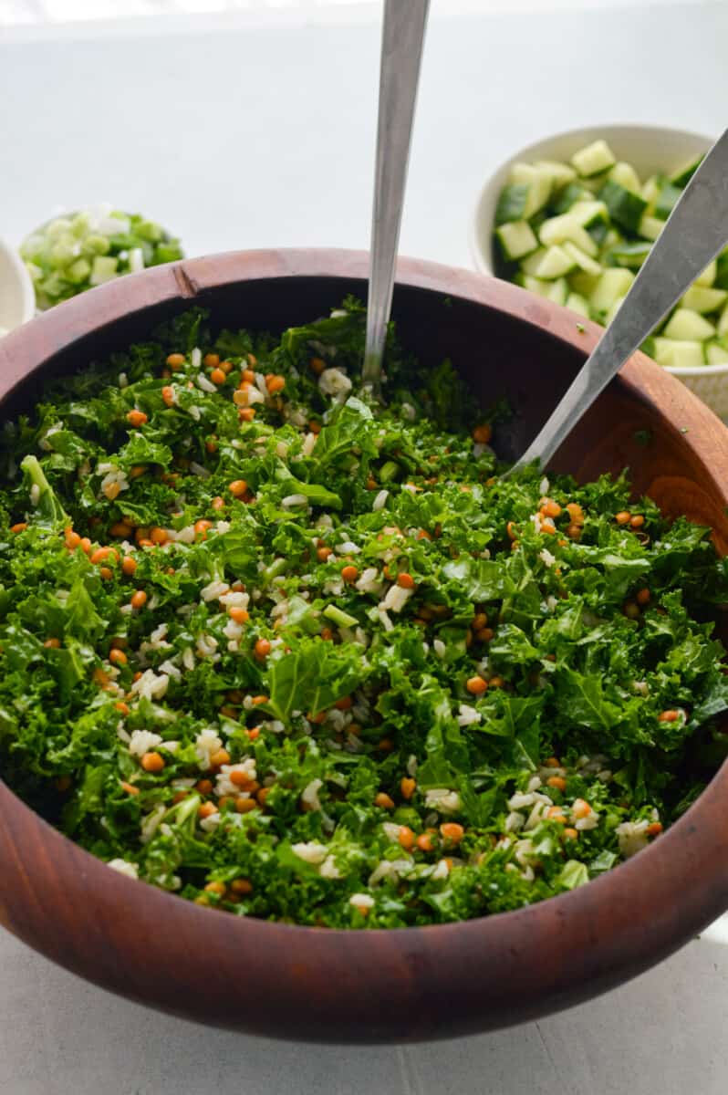 Mixing dill pickle salad.