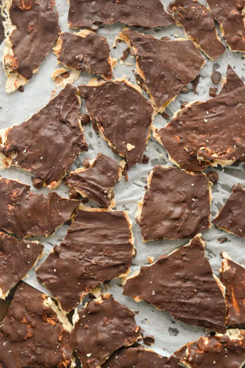 Breaking chocolate covered cookie dough bark into pieces.
