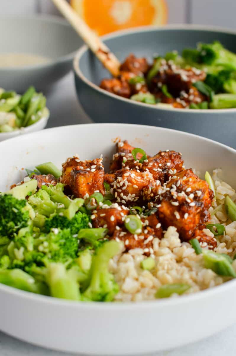 Sticky orange tofu bowl with broccoli and rice.