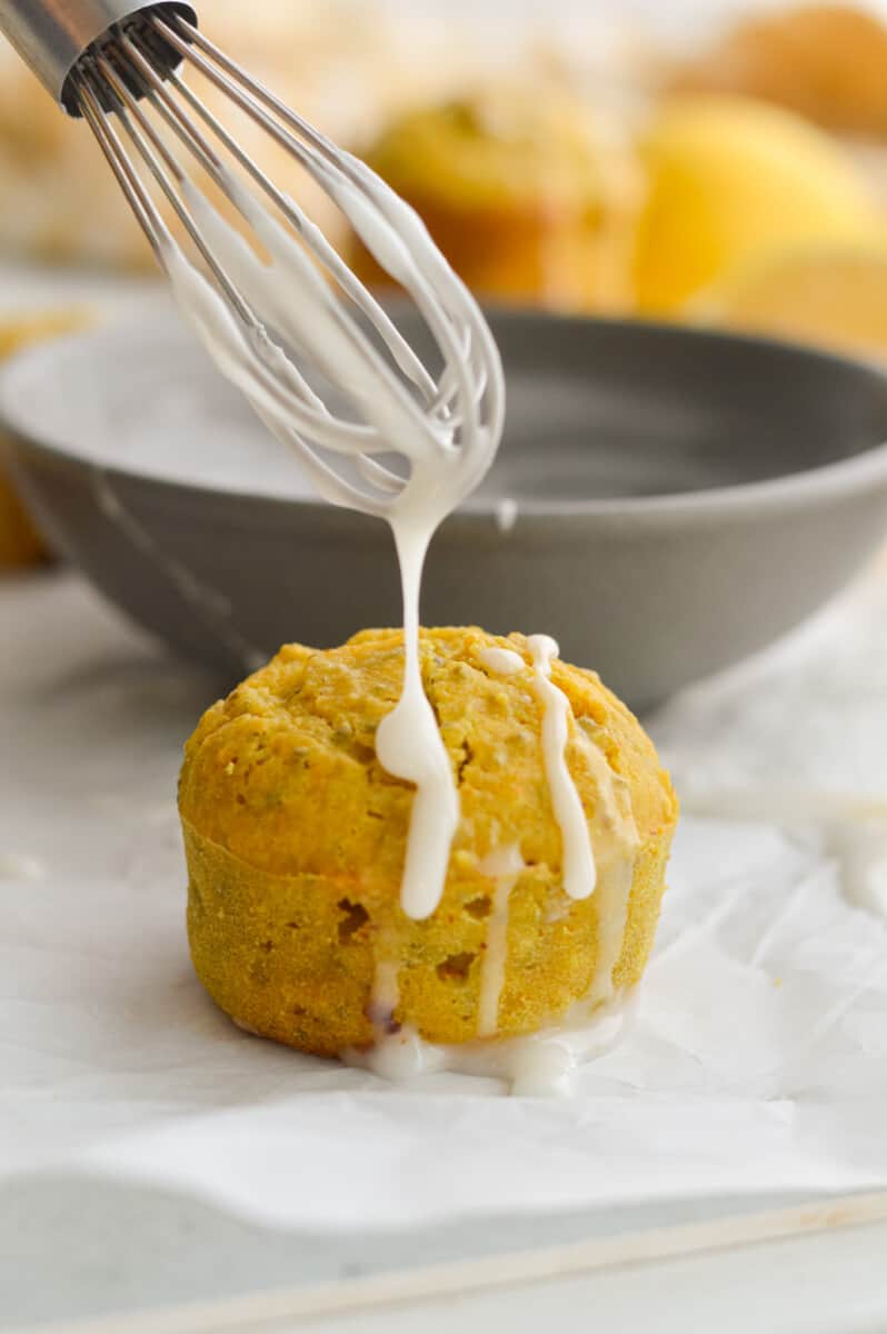 Adding lemon drizzle onto healthy lemon muffins.