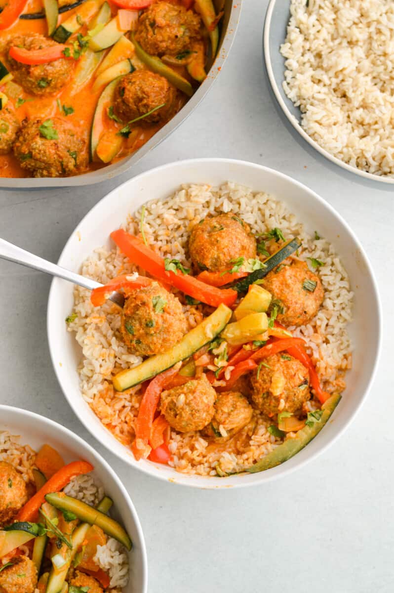 Birds eye of bowl of rice with Thai red curry with ginger chicken meatballs.