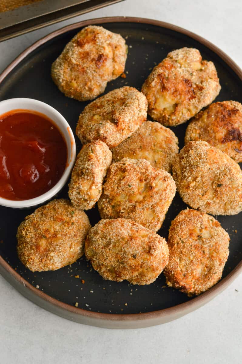Birds eye of a plate with homemade ground chicken nuggets served with ketchup.