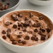 Bowl of chocolate Greek yogurt fruit dip with chocolate chips.