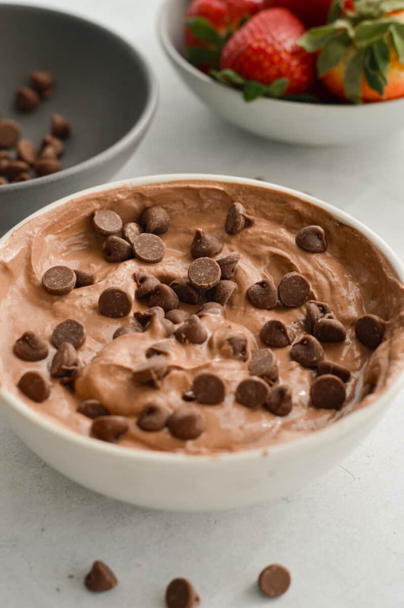 Bowl of chocolate Greek yogurt fruit dip with chocolate chips.