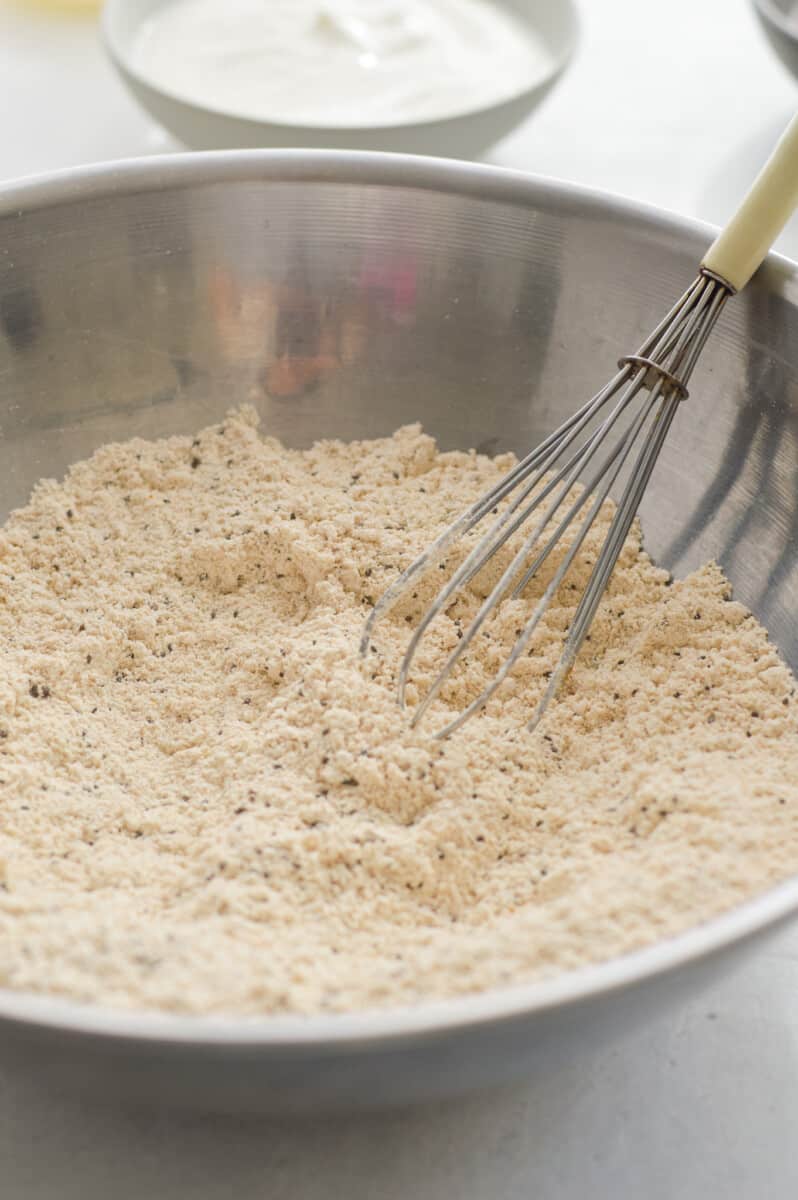 Whisking together oat flour, baking powder, baking soda, salt, chia seeds and turmeric.
