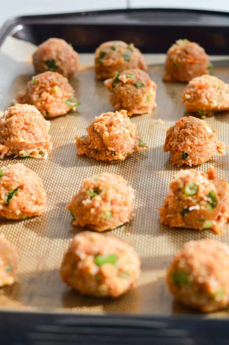 Ginger chicken meatballs on a baking tray.