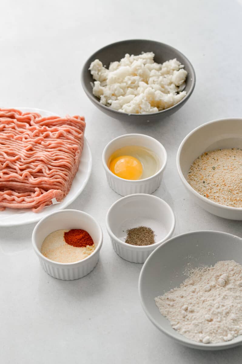 Ingredients including ground chicken, egg, spices, breadcrumbs and oat flour.
