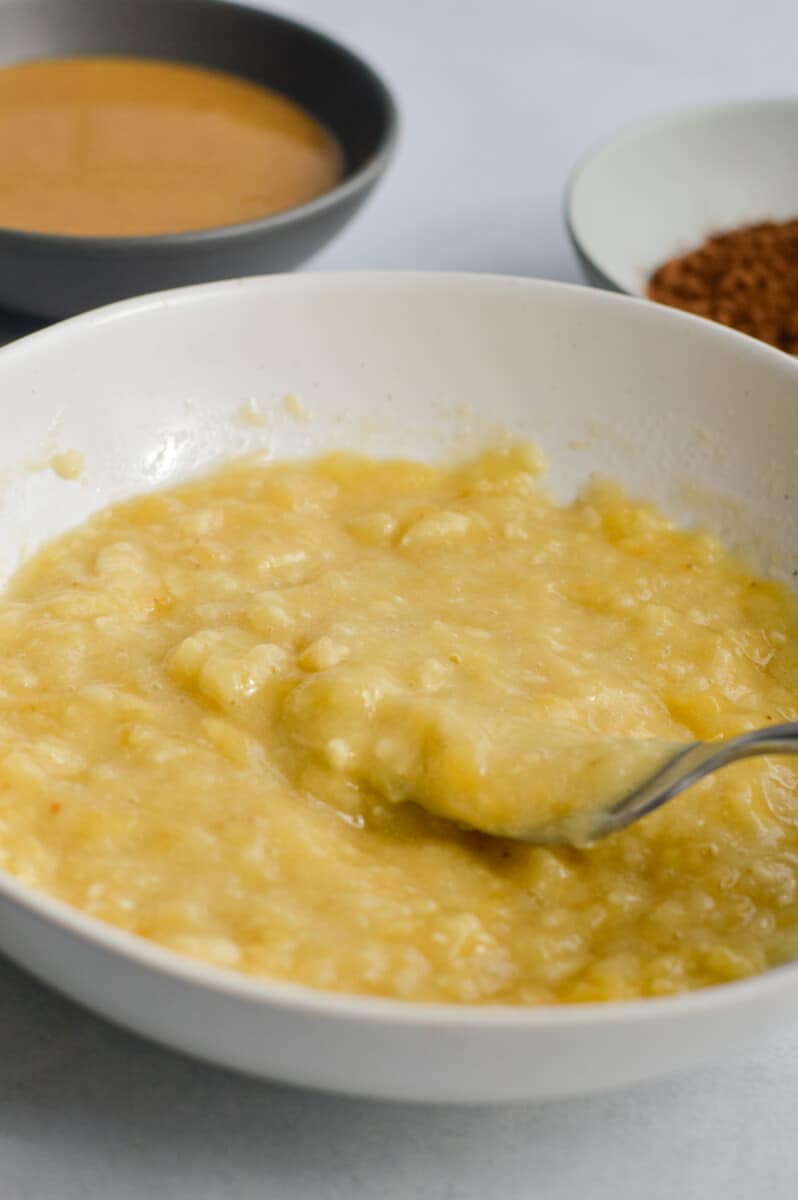 Mashing bananas with a fork.