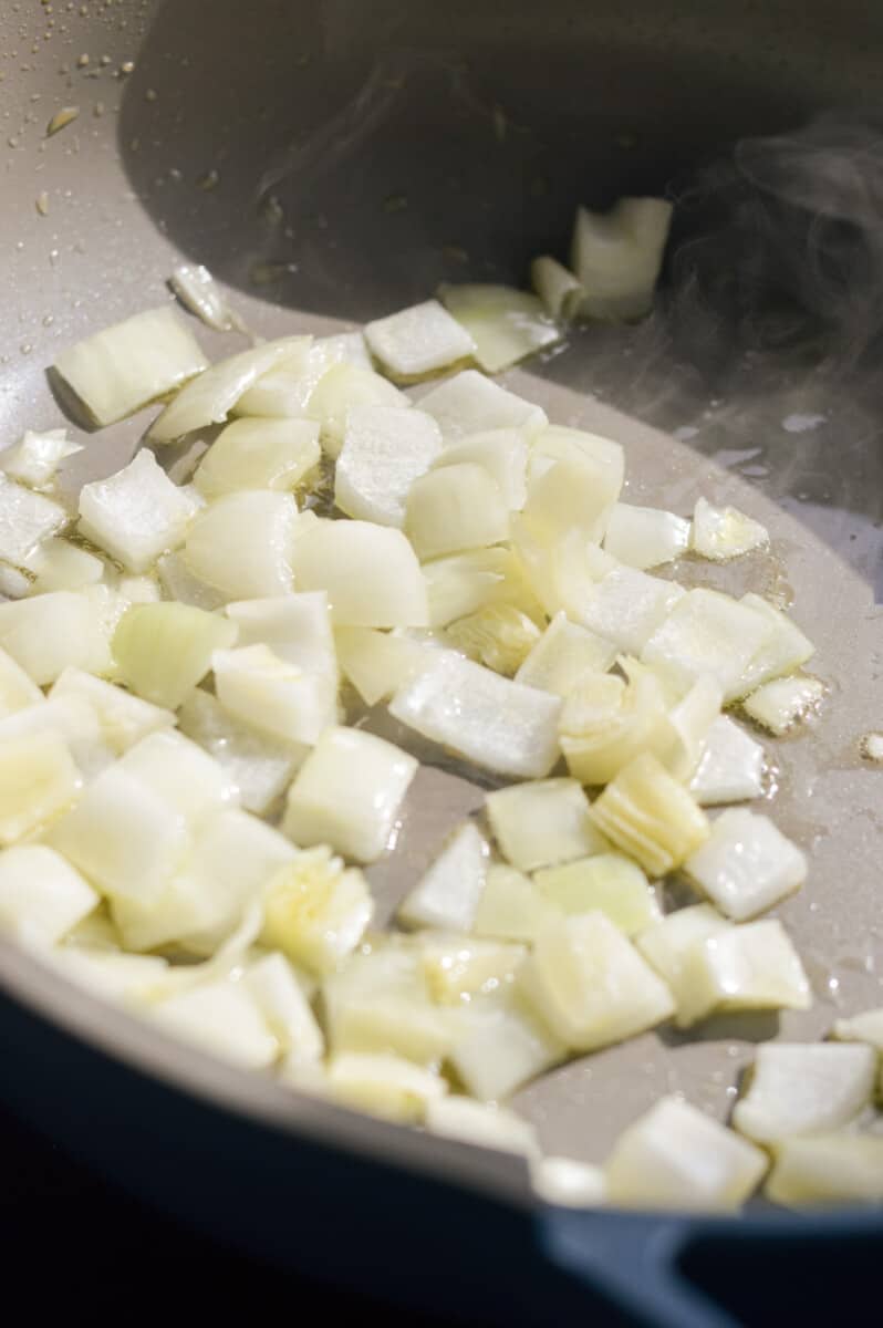 Sauteeing diced onions in olive oil.